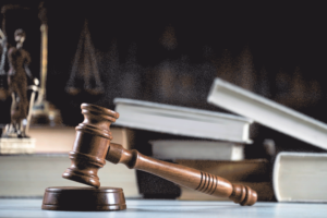 officer leading prisoner in handcuffs in corridor